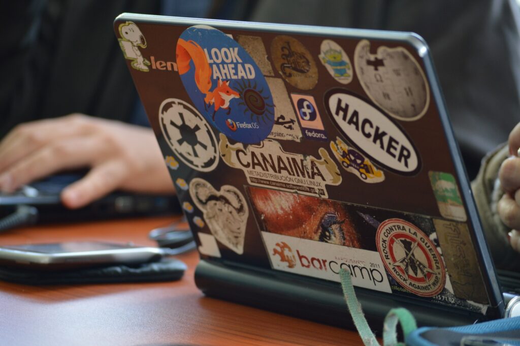 A laptop covered with hacker culture stickers. Photo by form PxHere https://pxhere.com/en/photo/555837